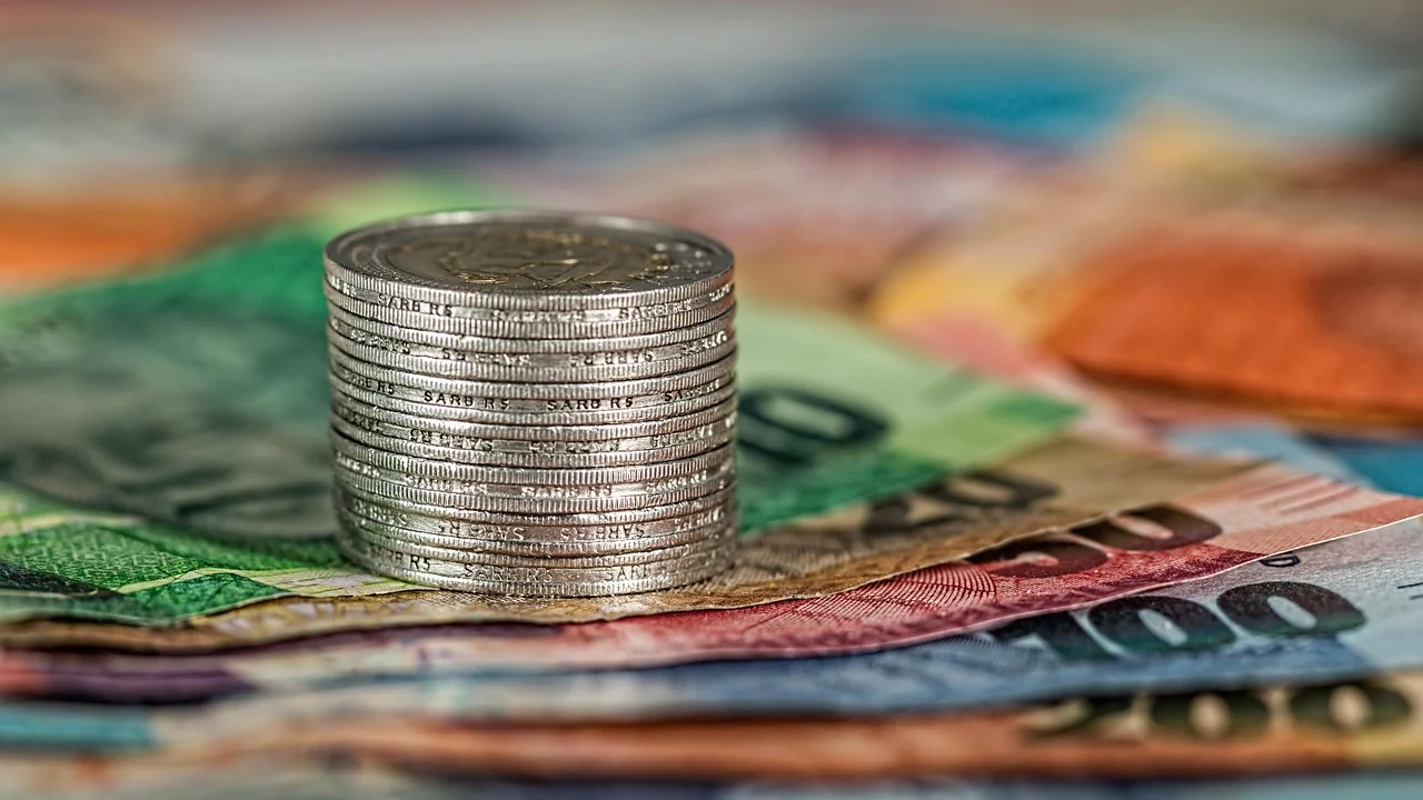 Cartão empresarial e calculadora sobre mesa de trabalho.