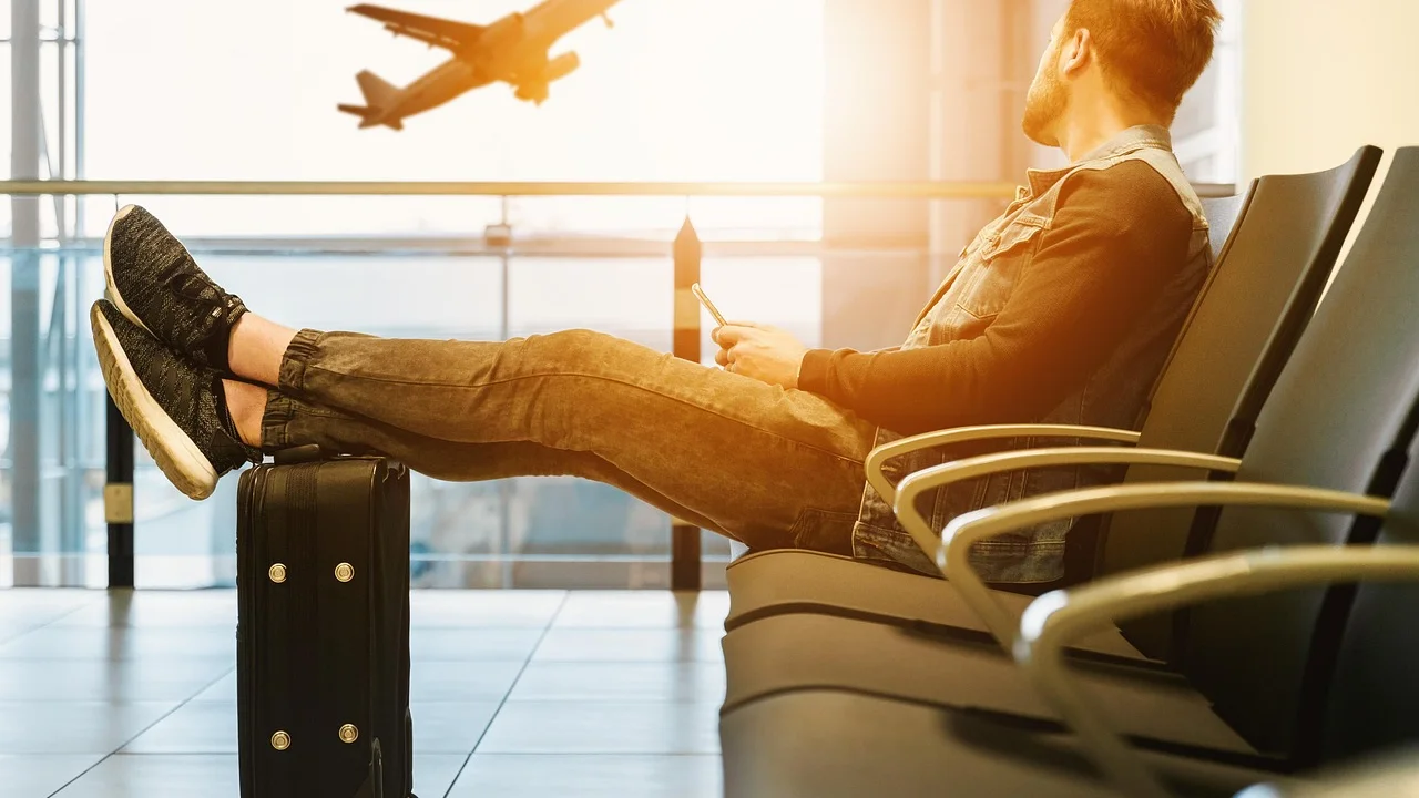 Passageiros aguardam o embarque em área de aeroporto.