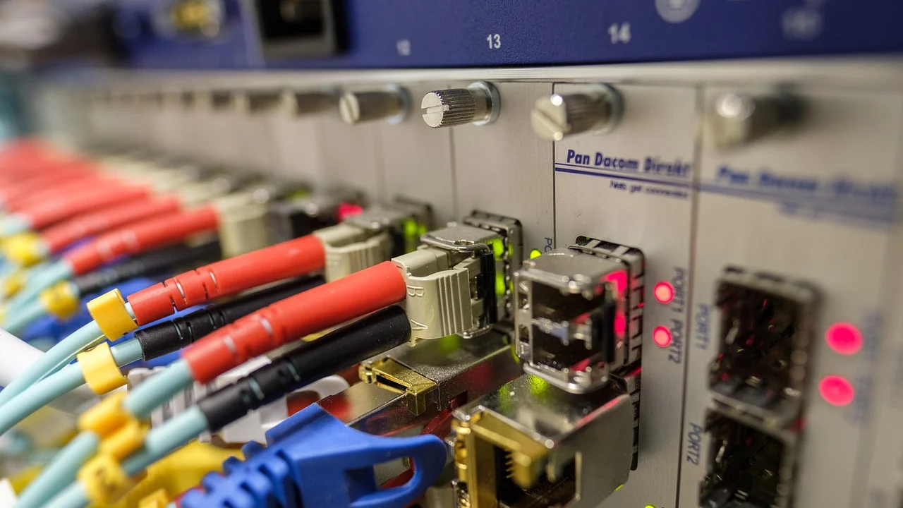 Técnico conecta cabo de fibra óptica ao ponto de entrada da residência.