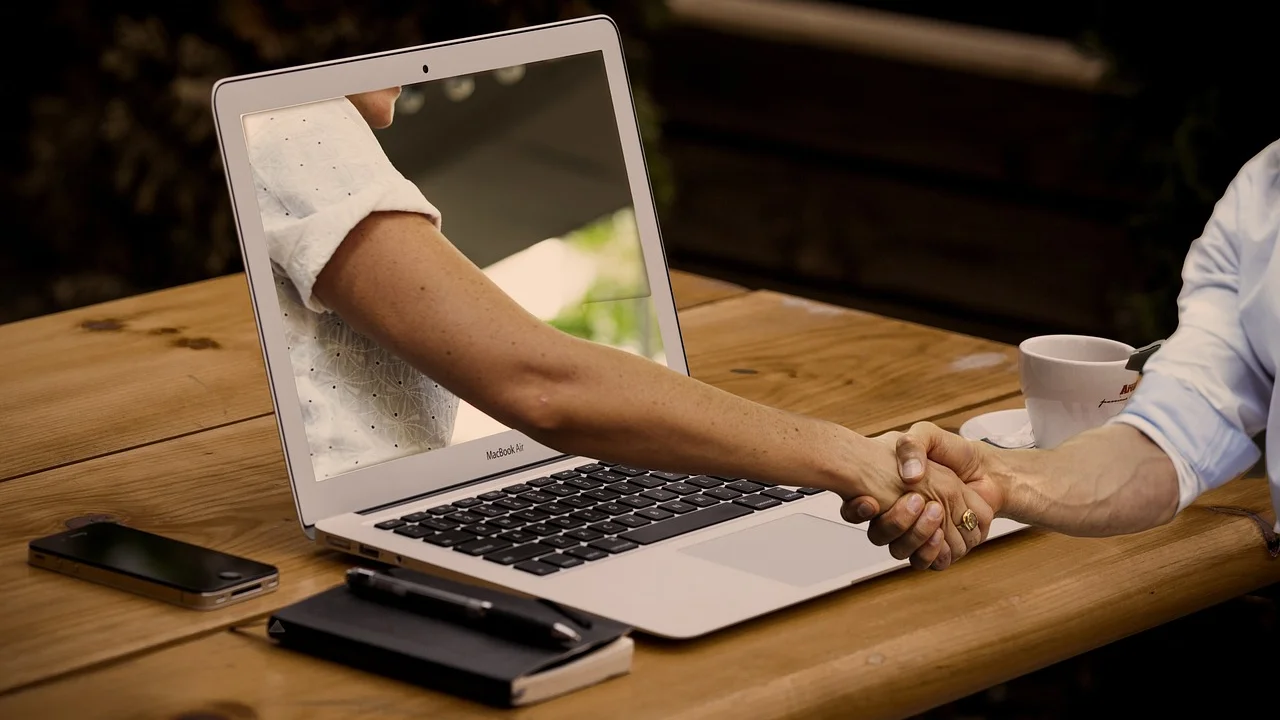 Networking presencial entre profissionais em ambiente corporativo.